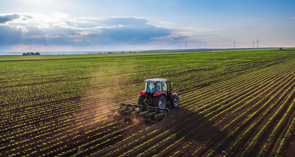 Modern tractor working farmland
