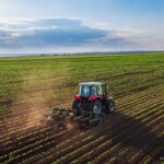 Modern tractor working farmland