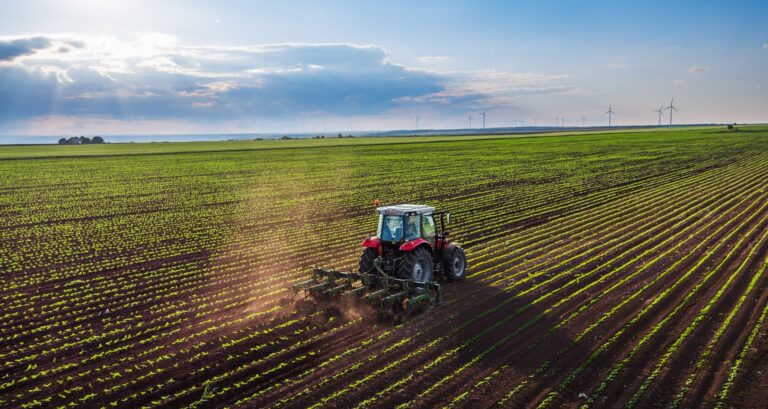 Modern tractor working farmland